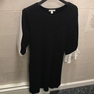 Black dress with flowy white sleeves.